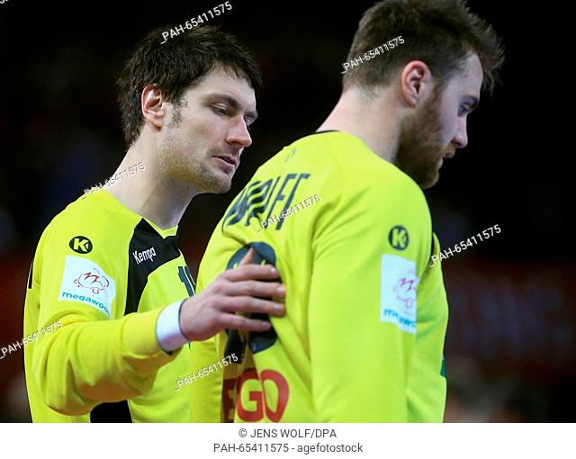Germany's goalkeeper Carsten Lichtlein (L) coaches team mate Andreas Wolff during the 2016 Men's European Championship handball group 2 match between Germany...