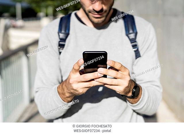 Close-up of man using smartphone in the city