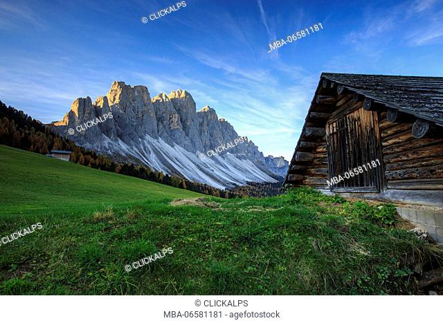 The early morning light illuminates Malga Zannes and the Odle in background, Funes Valley South Tyrol Dolomites Italy Europe