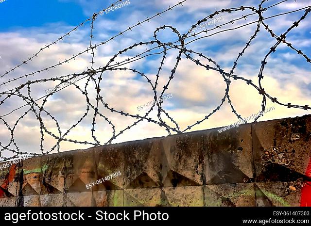 Barbed wire on a blue sky background. High quality photo