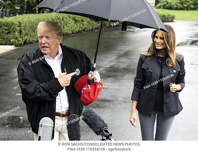 United States President Donald J. Trump gestures towards First lady Melania Trump as he speaks to reporters as he prepares to depart the White House in...
