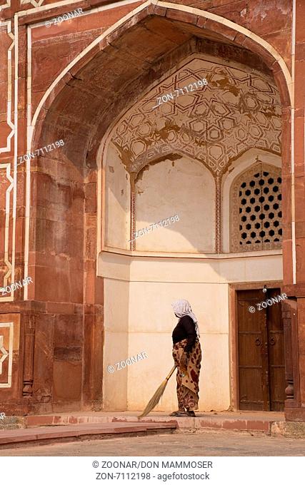Indian woman sweeping floor of Humayun's Tomb, Delhi, India