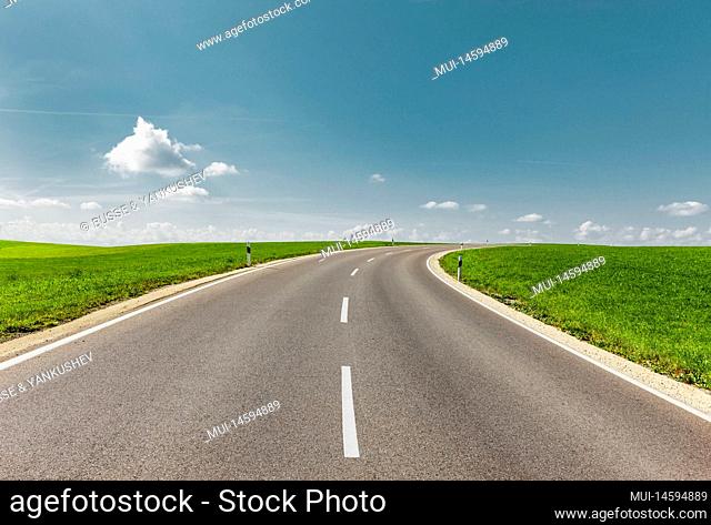 Country road in green landscape to horizon