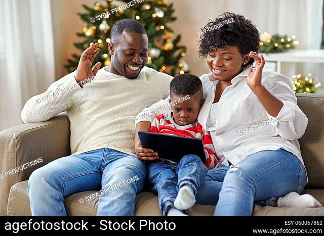 family with tablet pc has video call on christmas