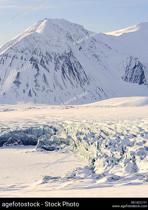 Glacier front of Fridtjovbreen and the frozen fjord Van Mijenfjorden. Landscape in Van Mijenfjorden National Park, (former Nordenskioeld NP)