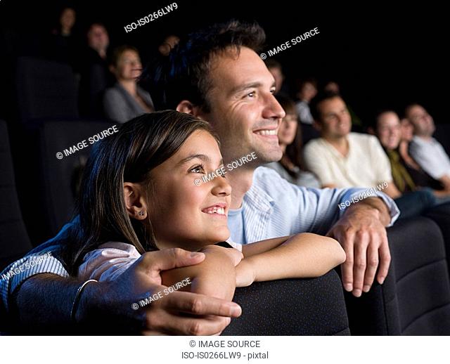 Father and daughter watching a movie
