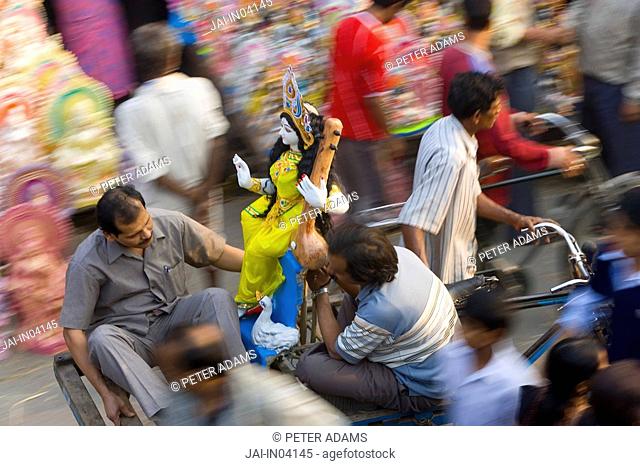 Sarasvati Female Hindu God idol being carried through street, Calcutta, West Bengal, Inida