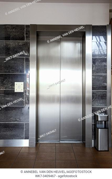 Building Elevator with closed door in apartment complex luxury silver