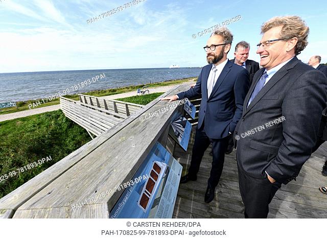 The Economy Minister of the state of Schleswig-Holstein, Bernd Buchholz (R), standing with his Danish counterpart Ole Birk Olesen (L) on a viewing platform of...