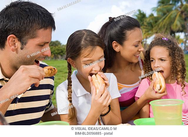 Hispanic family eating outdoors