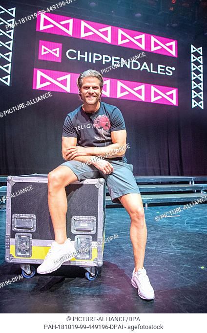 19 October 2018, Bavaria, Munich: 19 October 2018, Germany, Munich: Paul Janke, ex-""Bachelor"", sits in front of the logo of the Chippendales dance group