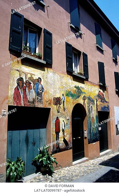 Via XX Septembre. Houses in street. Painted murals, images of local life
