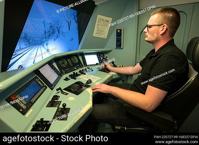 PRODUCTION - 30 June 2022, Saarland, Saarbrücken: Andreas Lutz controls a train in the rail simulator. All train drivers have to have their driving skills...