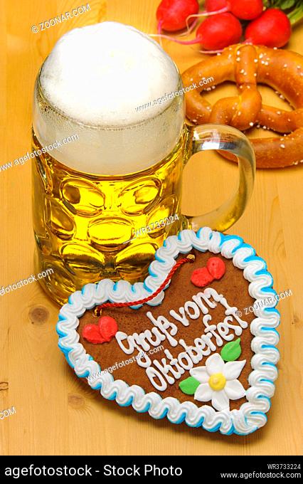 big glass filled with Bavarian lager beer and souvenir heart from Oktoberfest