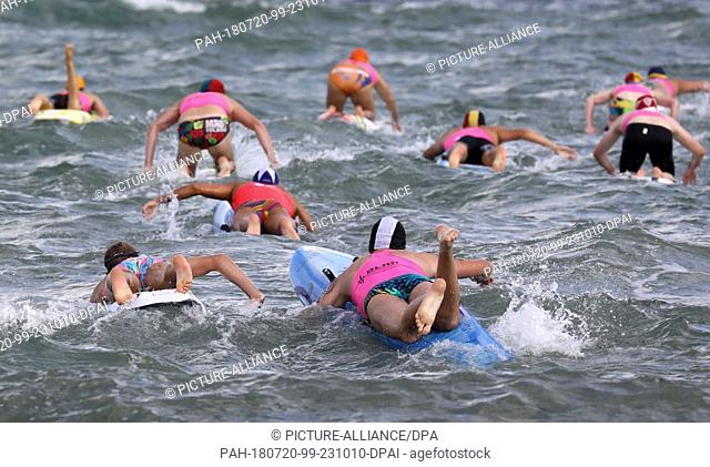 20 July 2018, Germany, Warnemuende: An oceanman race taking place at the Baltic Sea coast during the 22nd International DLRG Cup in rescue swimming