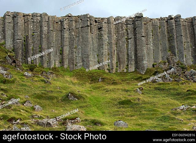 Wall of high basalt columns in Iceland. Volcanic Basalt Coloumn Formations