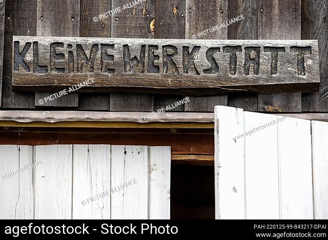 25 January 2022, Mecklenburg-Western Pomerania, Greifswald: A wooden plaque with the inscription ""Small workshop"" hangs above the entrance gate to the museum...
