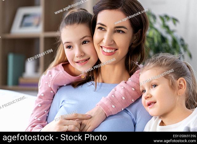 happy smiling mother with two daughters at home