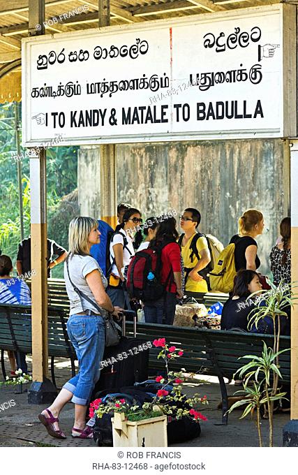 Foreign travellers await the popular Colombo to Badulla train at the railway station at Peradeniya, near Kandy, Sri Lanka, Asia