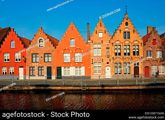 Typical Belgian cityscape Europe tourism concept - canal and old houses on sunset. Bruges (Brugge), Belgium