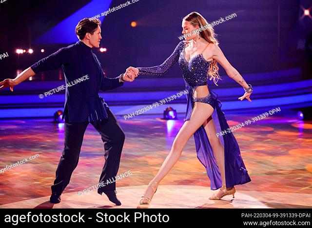 04 March 2022, North Rhine-Westphalia, Cologne: Cheyenne Ochsenknecht, influencer, and Evgeny Vinokurov, dance in the RTL dance show ""Let's Dance"" at the...