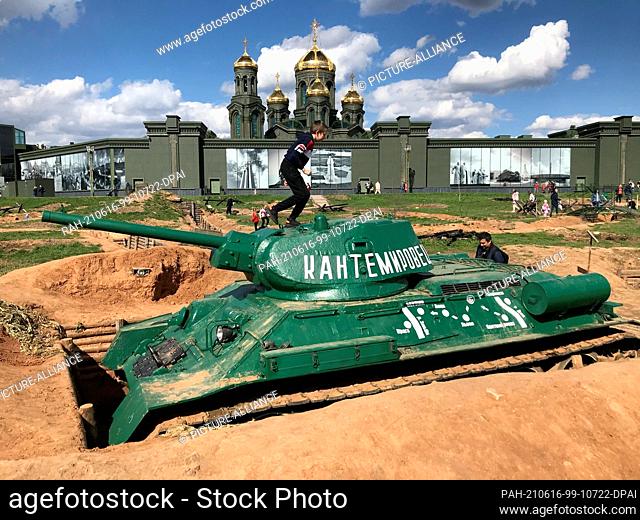 07 May 2021, Russia, Moskau: Children play on a Russian T34 tank in a position. The scene is part of the ""Patriot Park"" built from scratch by the Ministry of...