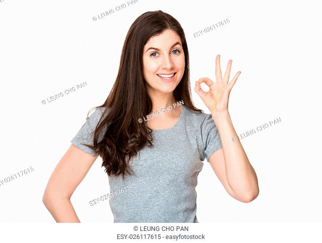 Brunette woman with ok sign gesture