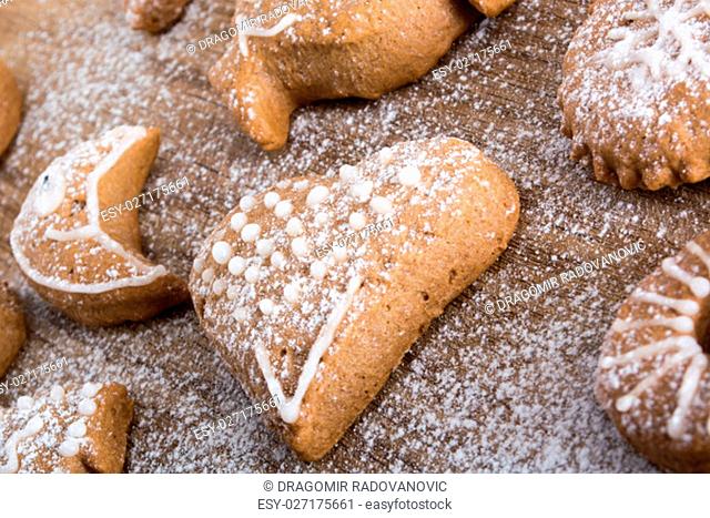 Gingerbread cookies on plate covered with powdered sugar