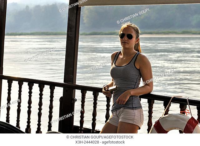 young woman standing at the railing of a cruise boat, owned by '' The Luang Say Lodge & Cruises'', on Mekong River, between Pakbeng and Luang Prabang