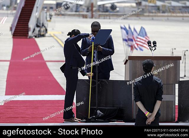13 July 2022, Israel, Lod: White House staff check the podium at Ben Gurion airport ahead of the arrival of US President Joe Biden for the state visit to Israel