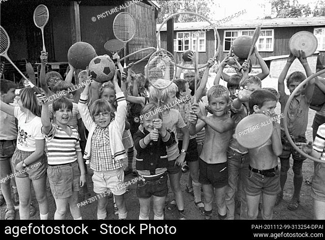 30 August 1983, Saxony, Eilenburg: In the summer of 1983 children show their play equipment at the children's holiday camp