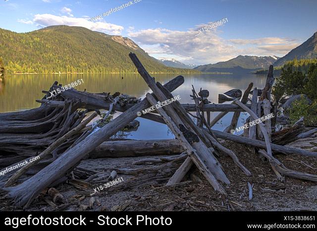 Early morning light bathes Lake Wenatchee in sunshine, on a calm, quiet spring day, making it an attrative vacation destination