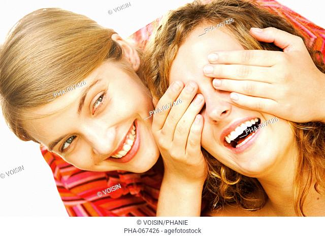 Woman covering her girlfriend's eyes with hands