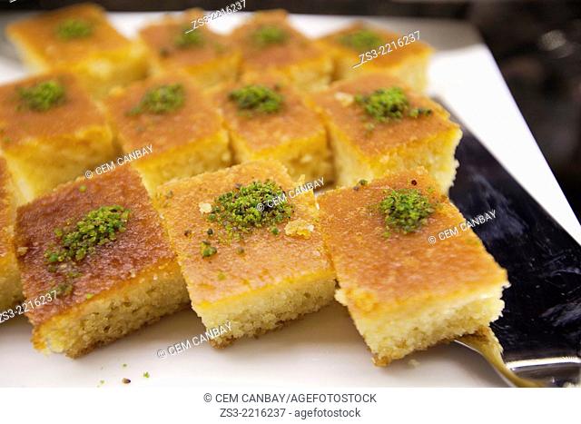 Revani, turkish dessert consisting of a mixture of semolina, wheat flour, eggs, sugar, oil, yogurt and lemon at the pastry shop, Taksim, Istanbul