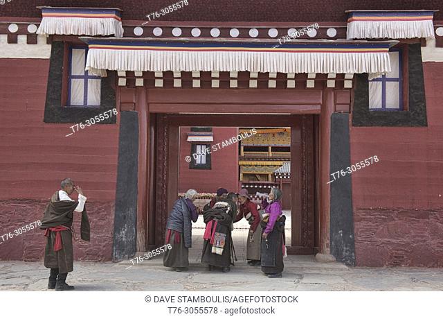 Tibetan pilgrims in front of Kerti Gompa, Langmusi, Gansu, China