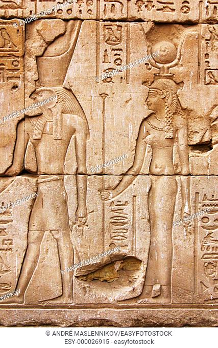 Stone relief of Isis and Horus at the temple of Horus in Edfu. Egypt