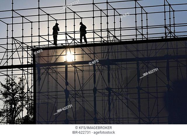 Two men installing a huge open-air screen, Djemaa el-Fna, Marrakech, Morocco, Africa