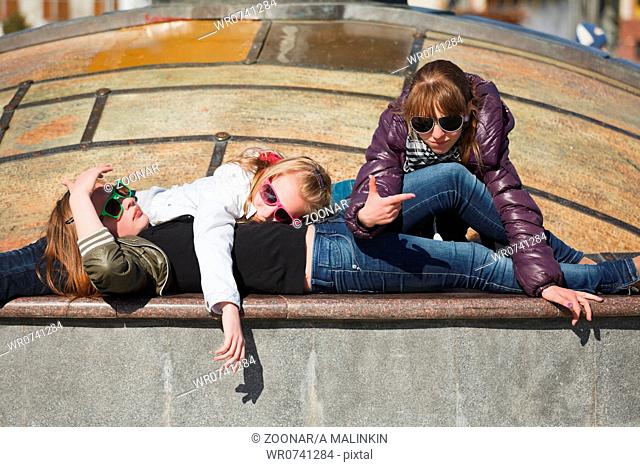 Teenage girls relaxing on a city street