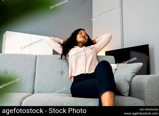 Young African Woman On Sofa Or Couch Dreaming