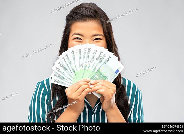 asian woman with hundred euro money banknotes