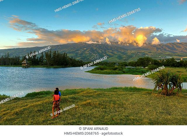 France, Reunion Island, Le Gol Saint Louis, creole couple beside a pond at sunset