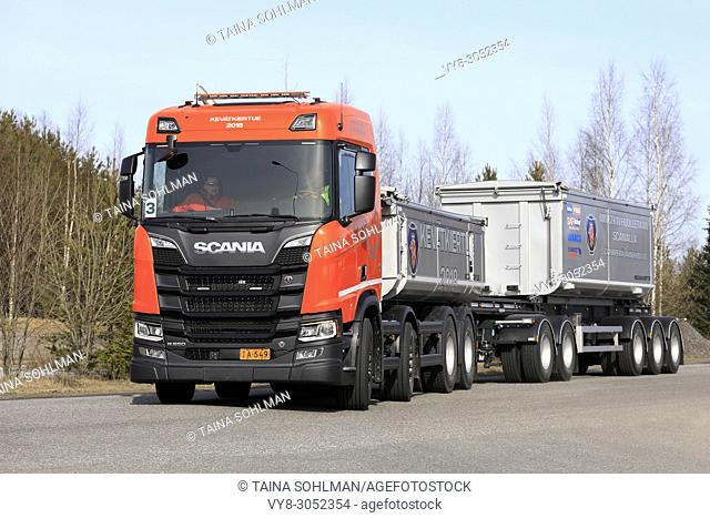 Orange Scania R650 B8X4 gravel truck combination on road test on a sunny day during Scania Tour Turku 2018 in Lieto, Finland - April 12, 2018