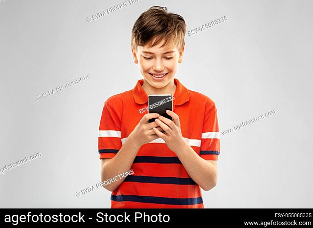 portrait of happy smiling boy with smartphone