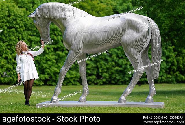 02 June 2021, Schleswig-Holstein, Büdelsdorf: Exhibition moderator Hanna Kremp stands by the sculpture ""Steel Horse"" by artist Michal Gabriel (Czech Republic)...