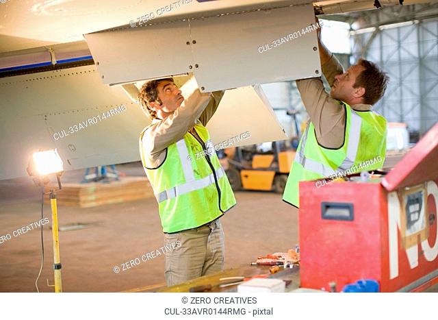 Aircraft workers checking airplane