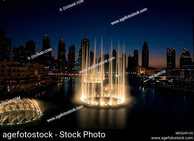 DUBAI UAE 31 JANUARY 2017 famous musical fountain in Dubai with skyscrapers in the background on a beautiful summer evening