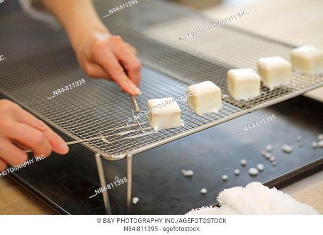 Pastry chef making small pastries