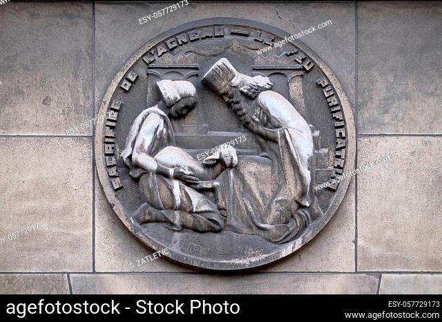 Sacrifice of the lamb - The purifying fire. Stone relief at the building of the Faculte de Medicine Paris, France