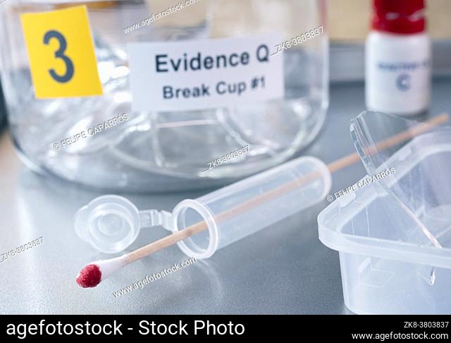 Blood-stained glass sample in an evidence cup, concept image