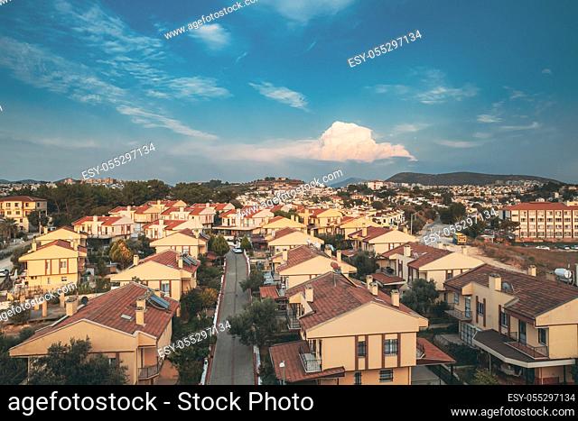 Beautiful Cityscape Of Turkish Town. White Residential Houses On Hillside. Real Estate Suburb In Summer Evening